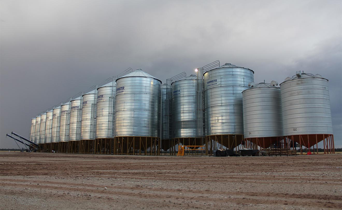 Farm with grain silos on an overcast day