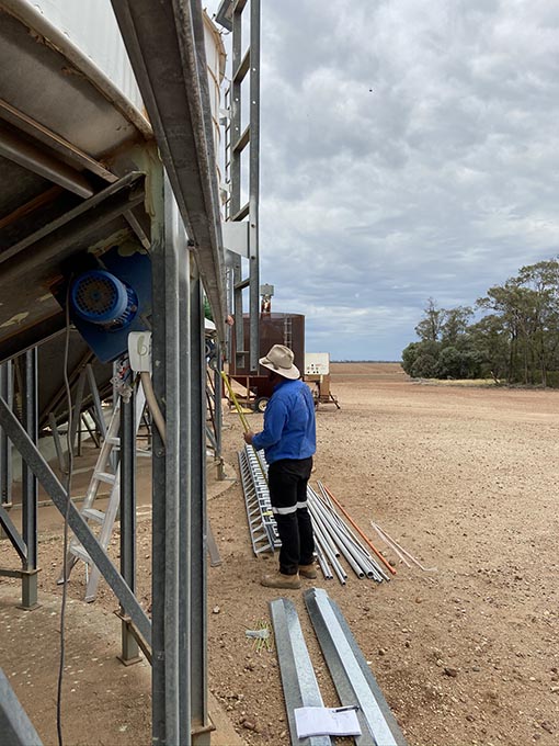 Control Unlimited team member working on silos on site